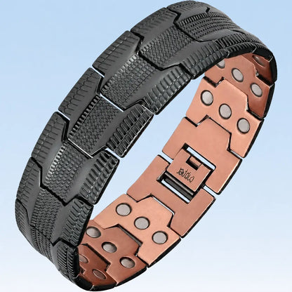 A segmented magnetic therapy bracelet made of black textured metal and rose gold-toned metal, shown on a light blue gradient background.