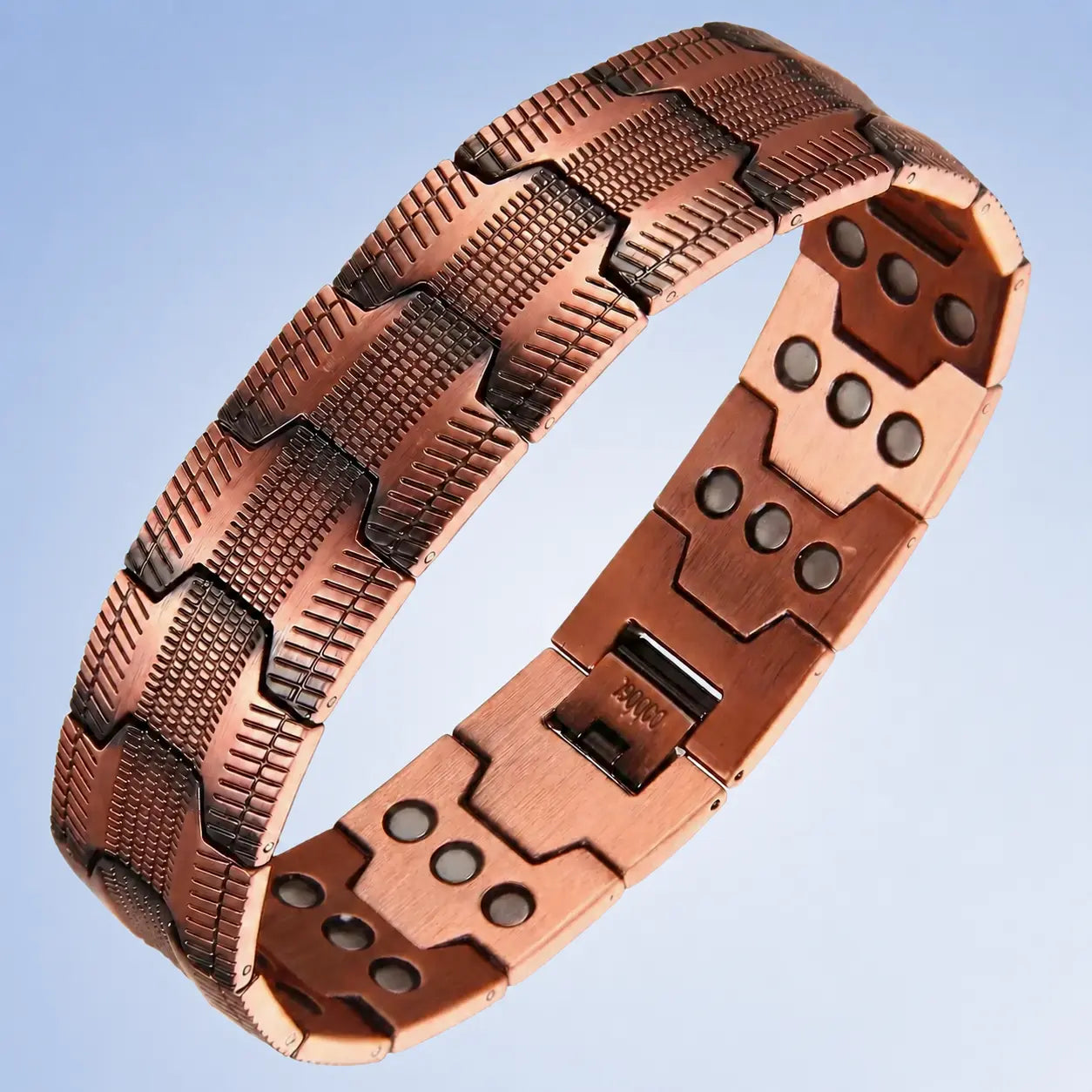 A copper-colored magnetic therapy link bracelet shown on a light blue gradient background.